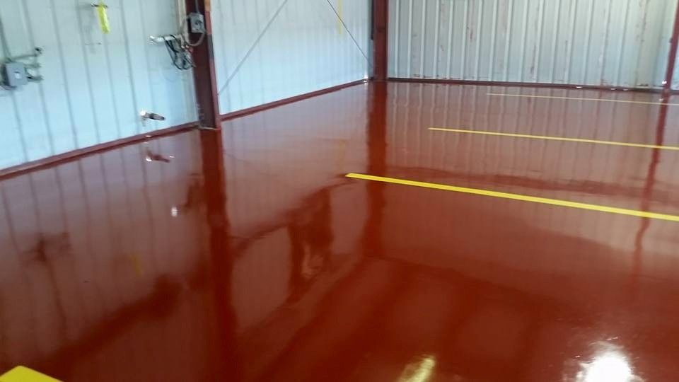 A red garage floor with a yellow line on it.