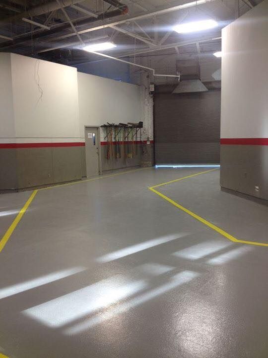 An empty garage with a yellow line on the floor
