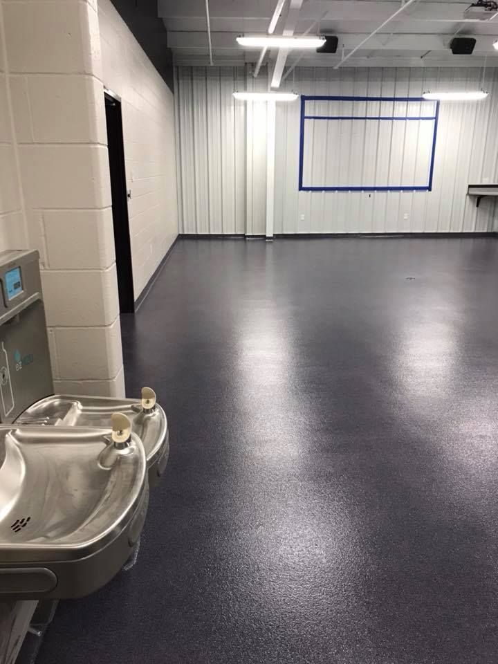 A bathroom with two sinks and a water fountain.