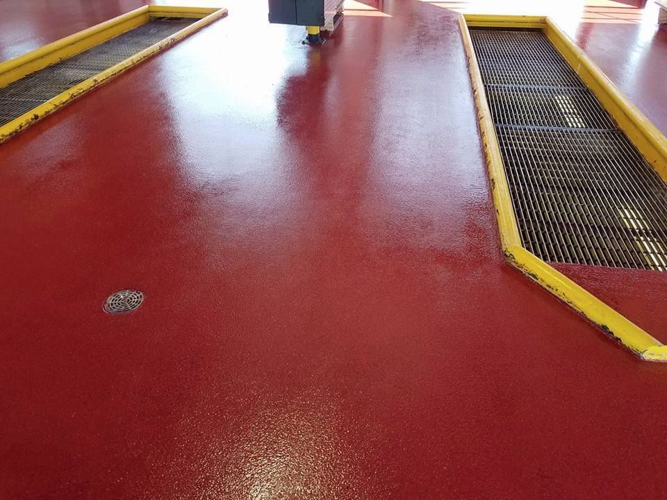 A red floor with a yellow border in a garage.