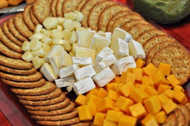 A plate of crackers and cheese on a table.