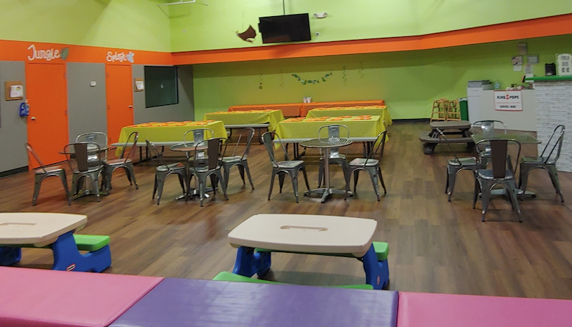 A large room with tables and chairs in it.
