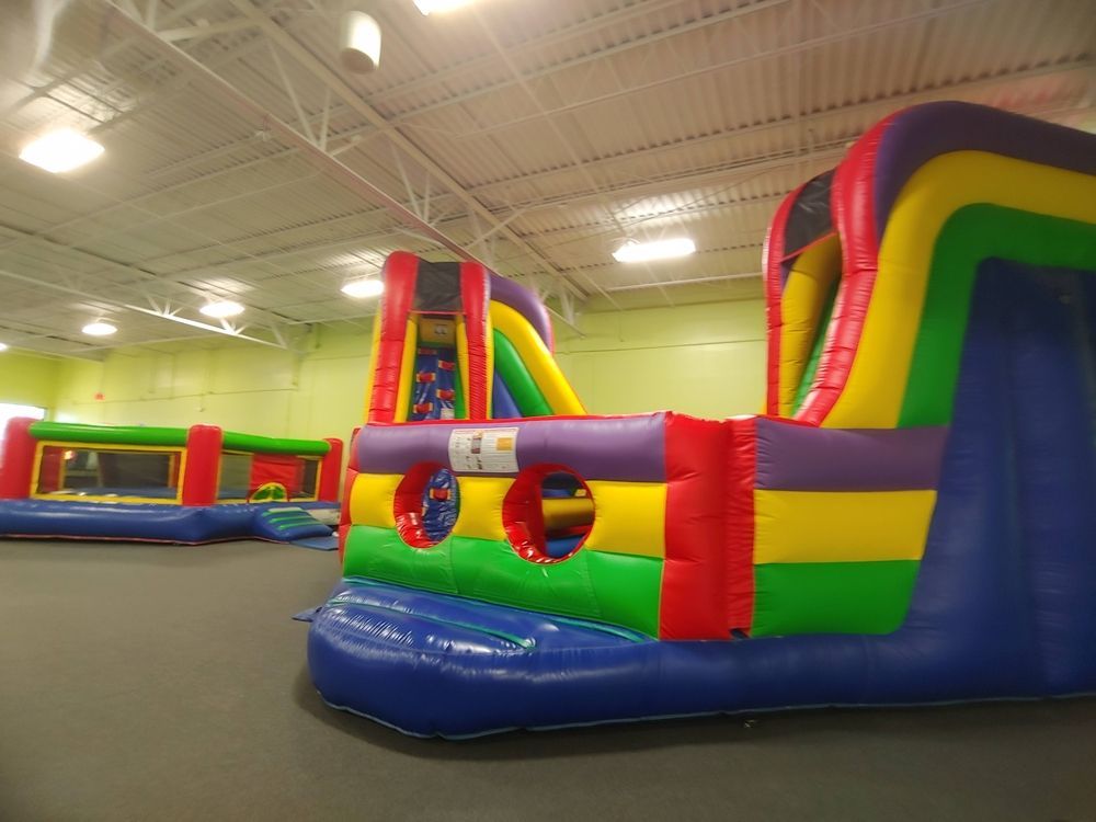 A bunch of colorful bouncy houses in a room