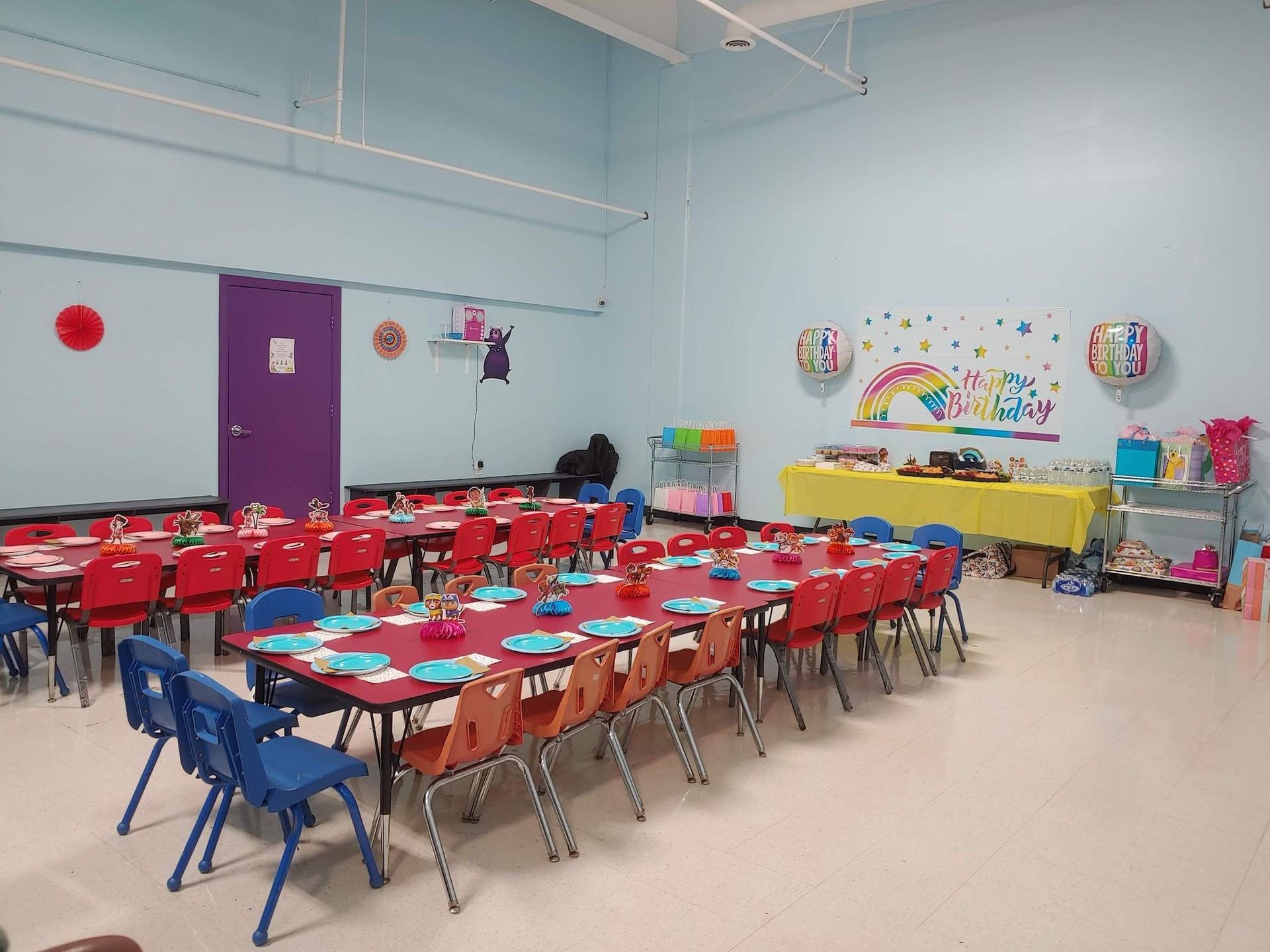 A room with tables and chairs set up for a party