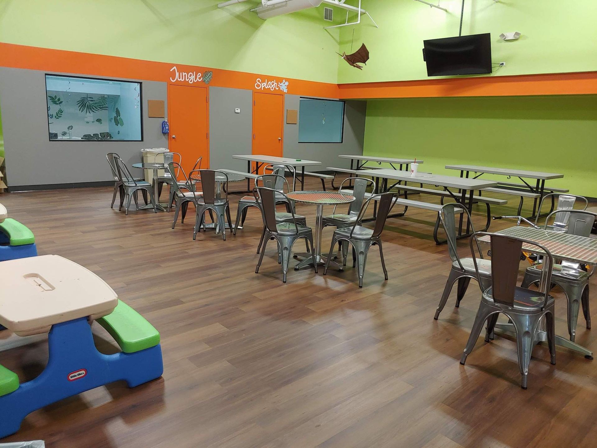 A large room with tables and chairs in it.