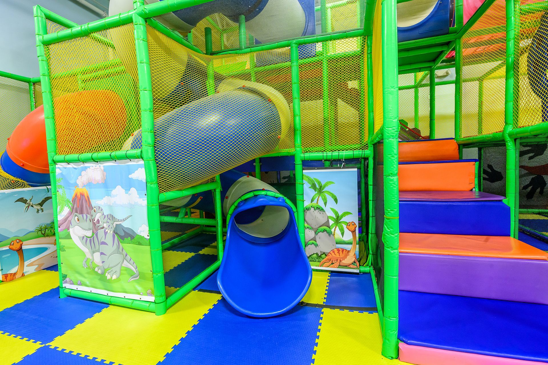 Play structure with blue, green, and orange elements.