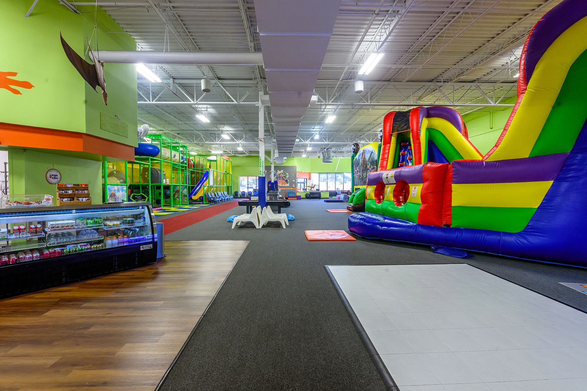 Indoor play center with inflatable slides and structures.