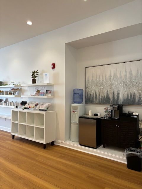 A woman 's feet with purple nail polish and a flower in the background