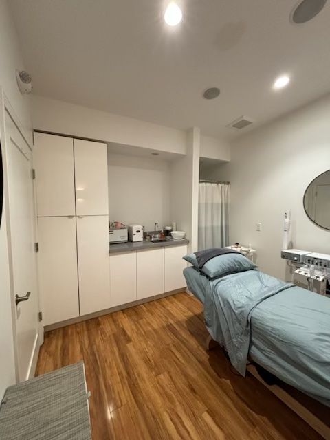 A room with a bed and a mirror in it