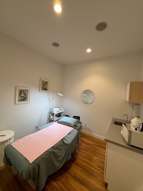 A room with a bed and a sink in it