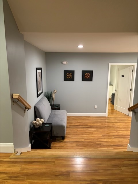 A living room with a couch and two pictures on the wall