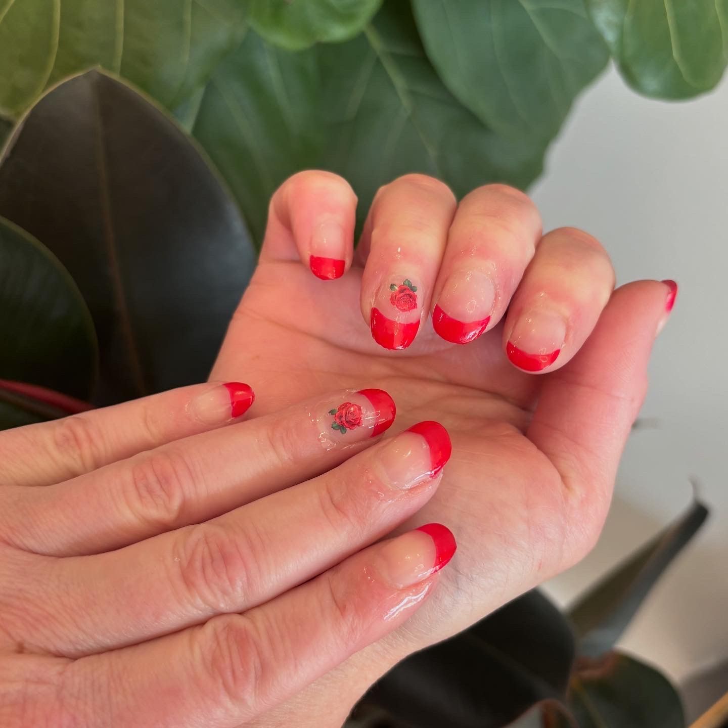 A close up of a woman 's hand with red nails