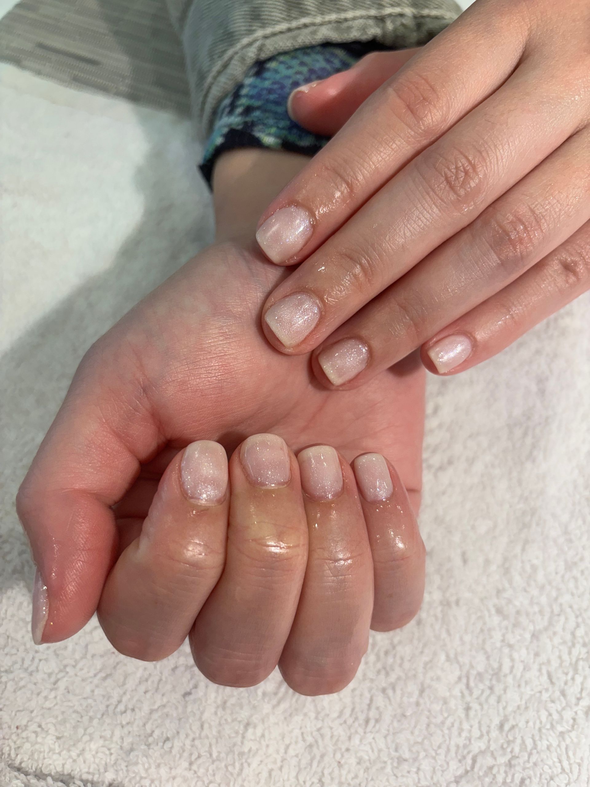 A close up of a person 's nails on a white towel.