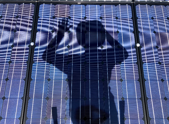 House roof with blue solar panels installed on a sunny day