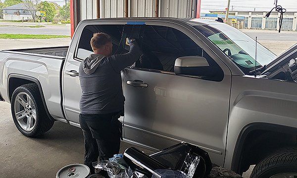Auto mechanic tinting the pick up truck