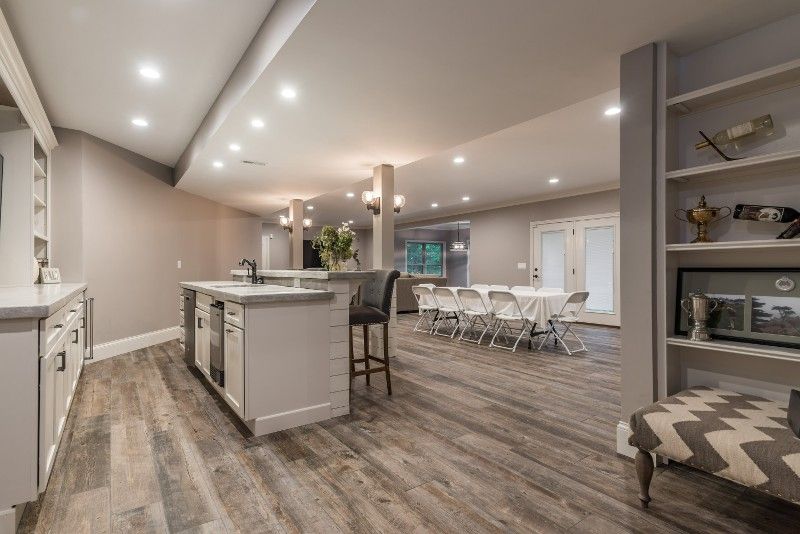 A basement with a kitchen , dining room , and living room.