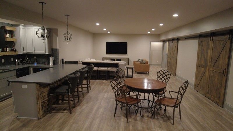 There is a table and chairs in the middle of the room.