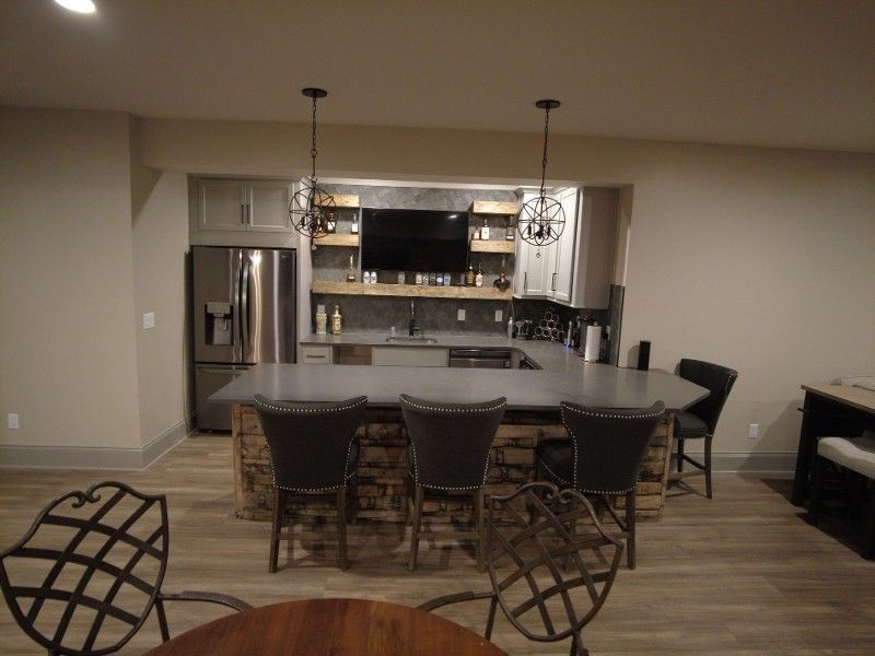 A kitchen with a table and chairs and a refrigerator