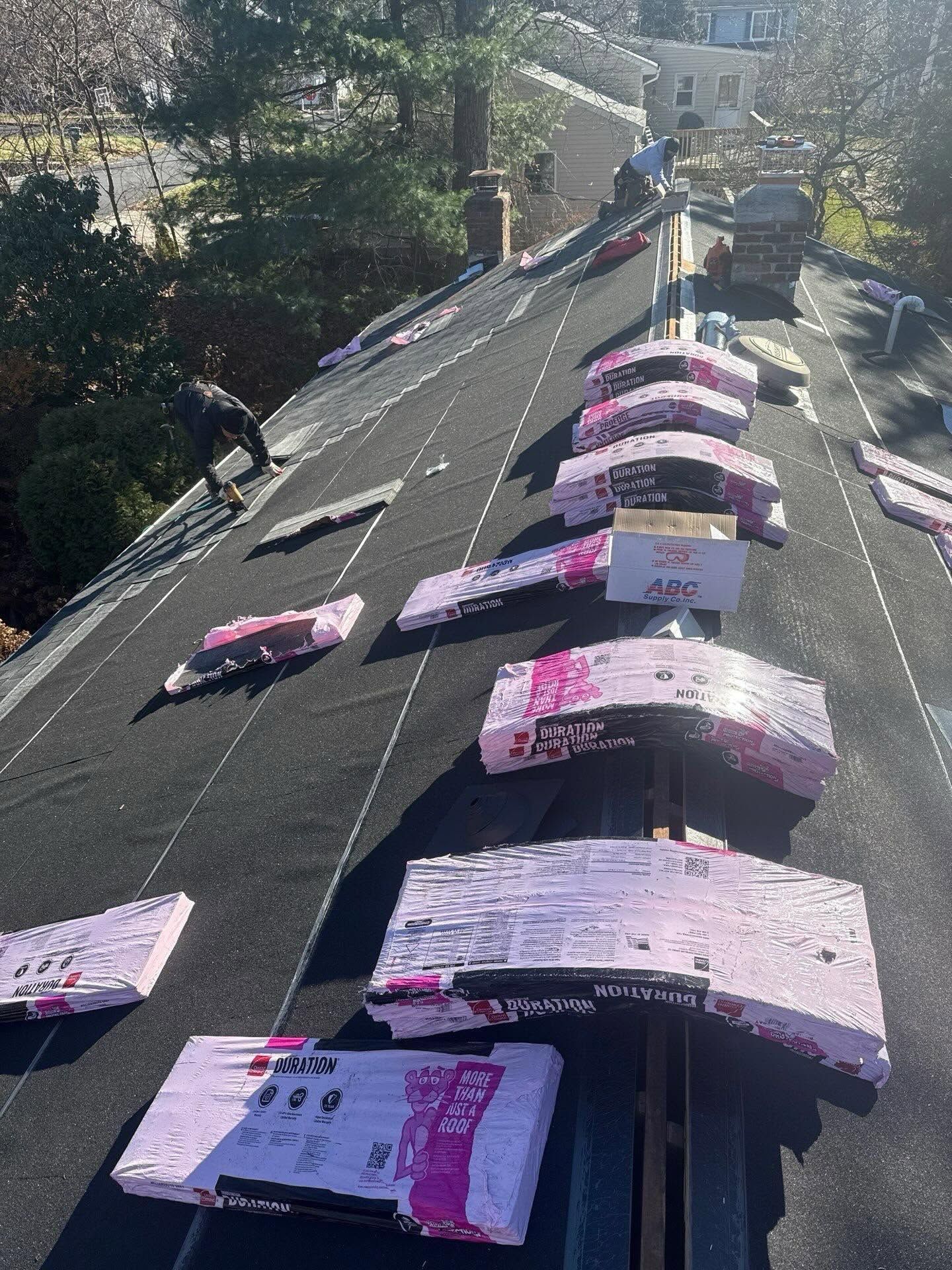 Pink signs lined up on a sloped roof, viewed from above in bright daylight