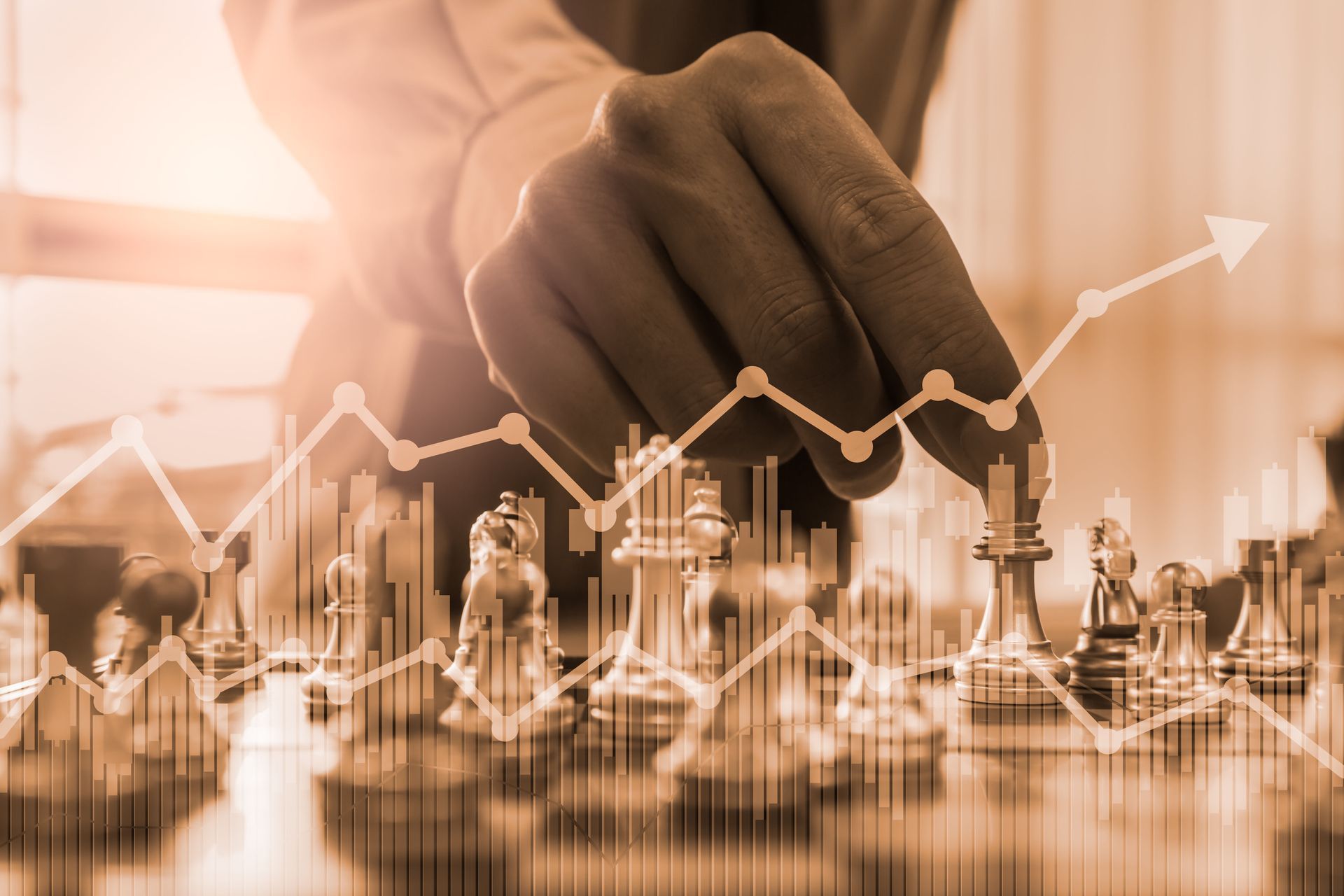 A person moves a chess piece on a board, overlaid with financial bar charts and upward-trending line graphs in sepia tone.