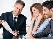 Happy young couple discussing with agent