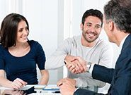 Happy couple seal a deal with their personal financial advisor at home