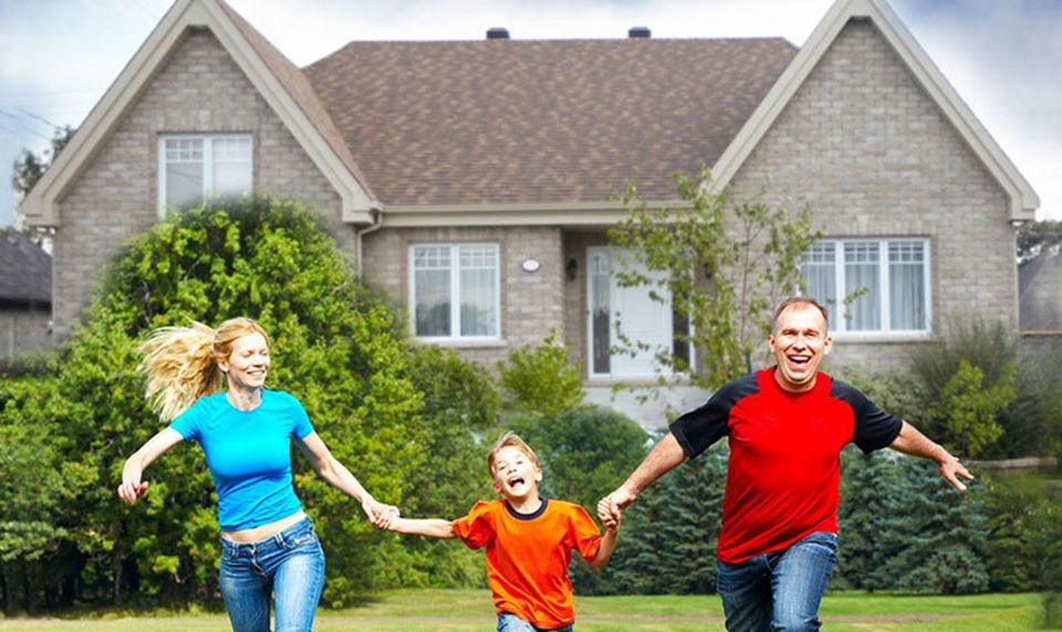 Happy family near new house