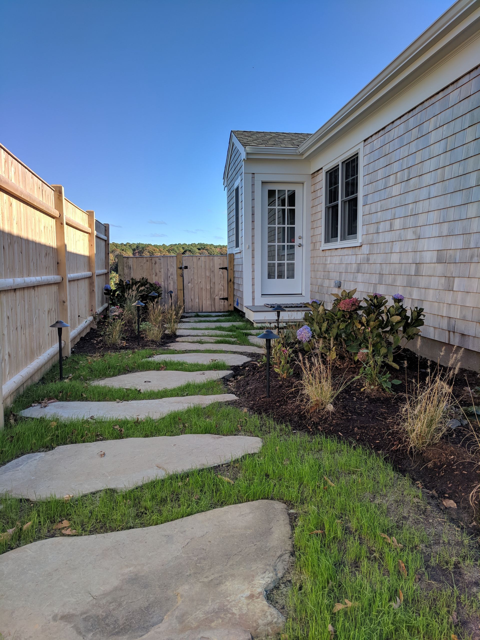 A stone walkway leading to the front door of a house.