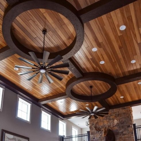 Wood ceiling with dark trim, recessed lights, and two large ceiling fans.
