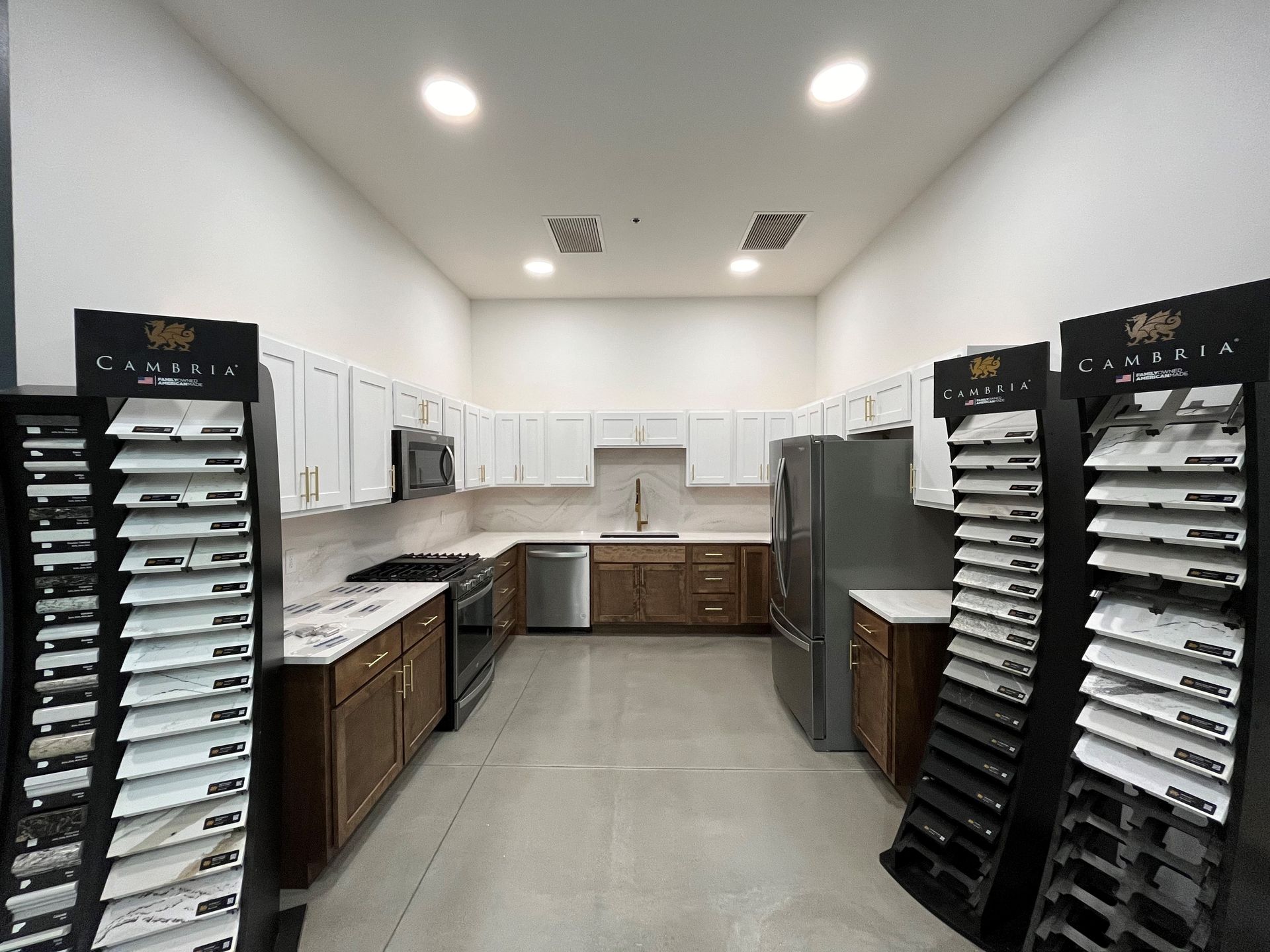 Kitchen showroom featuring white and brown cabinets, with samples on display.