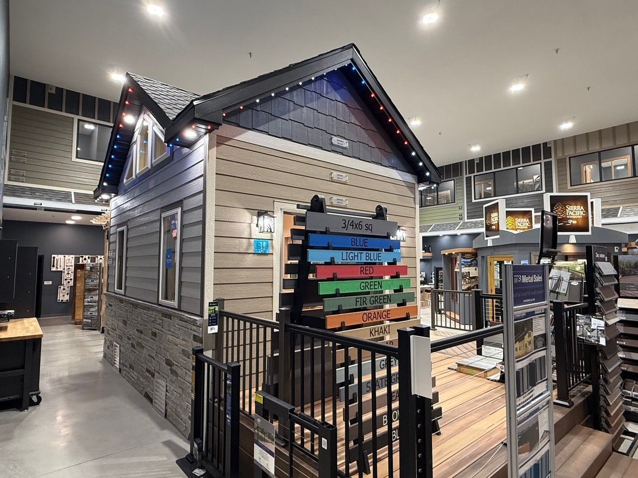 Miniature house model in a store, showcasing exterior siding options.