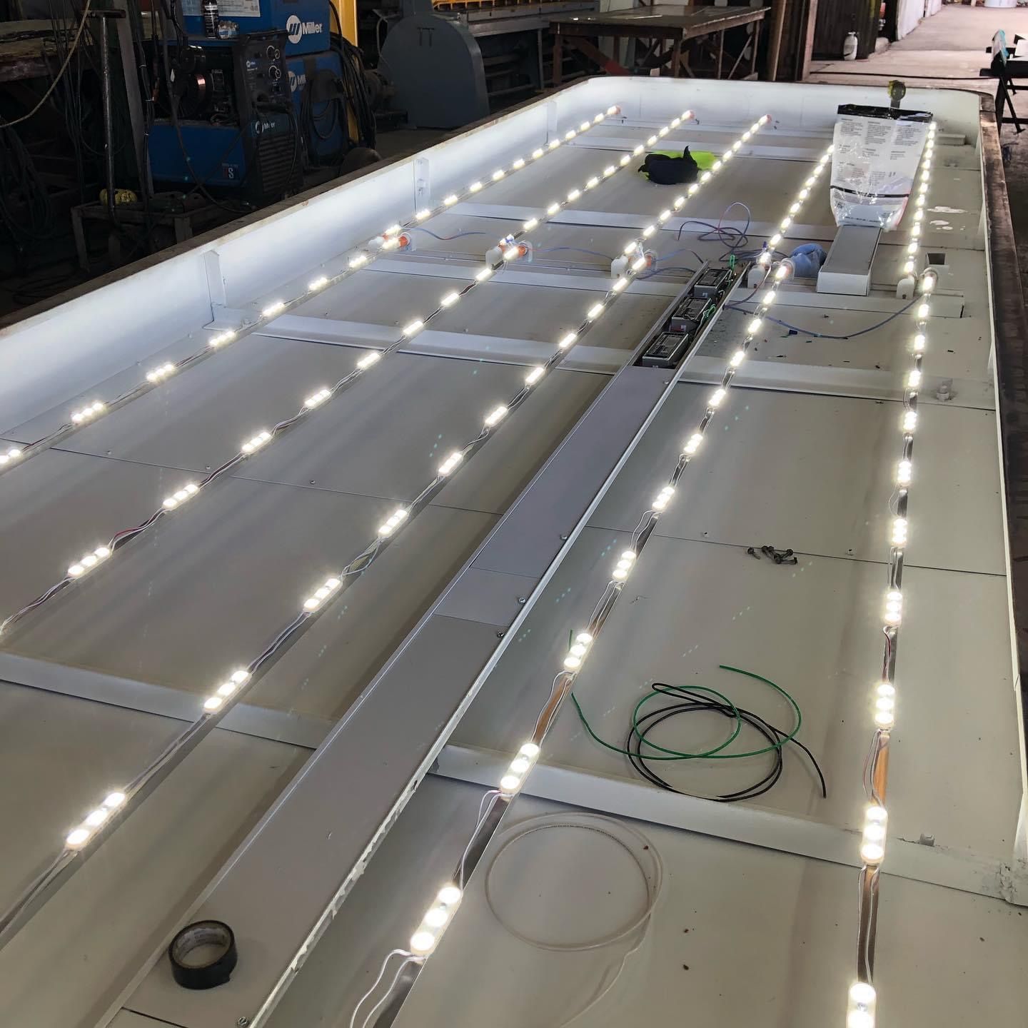 A Baldwin sign is lit up at night on the side of a building