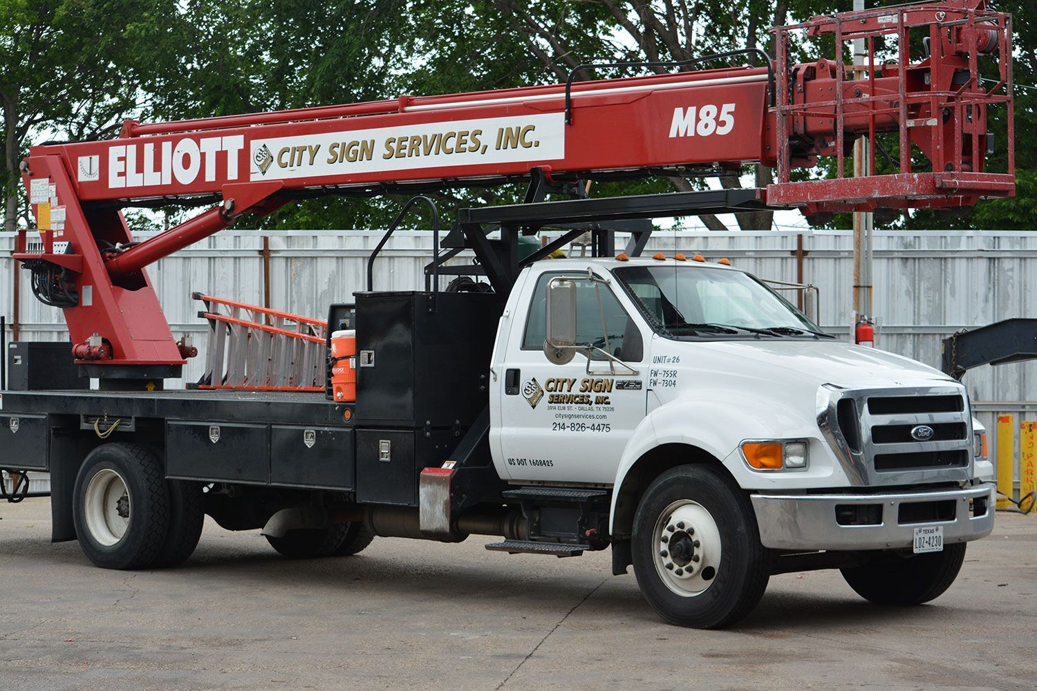 A red and white elliott truck is parked in a parking lot