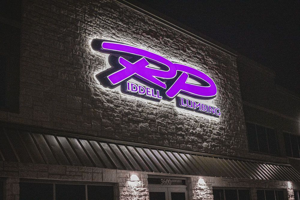 A purple sign on the side of a building that says RP