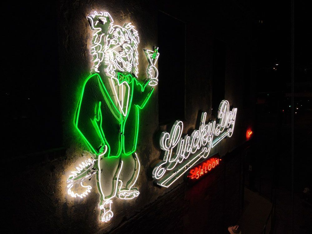 A neon sign of a man in a suit and tie