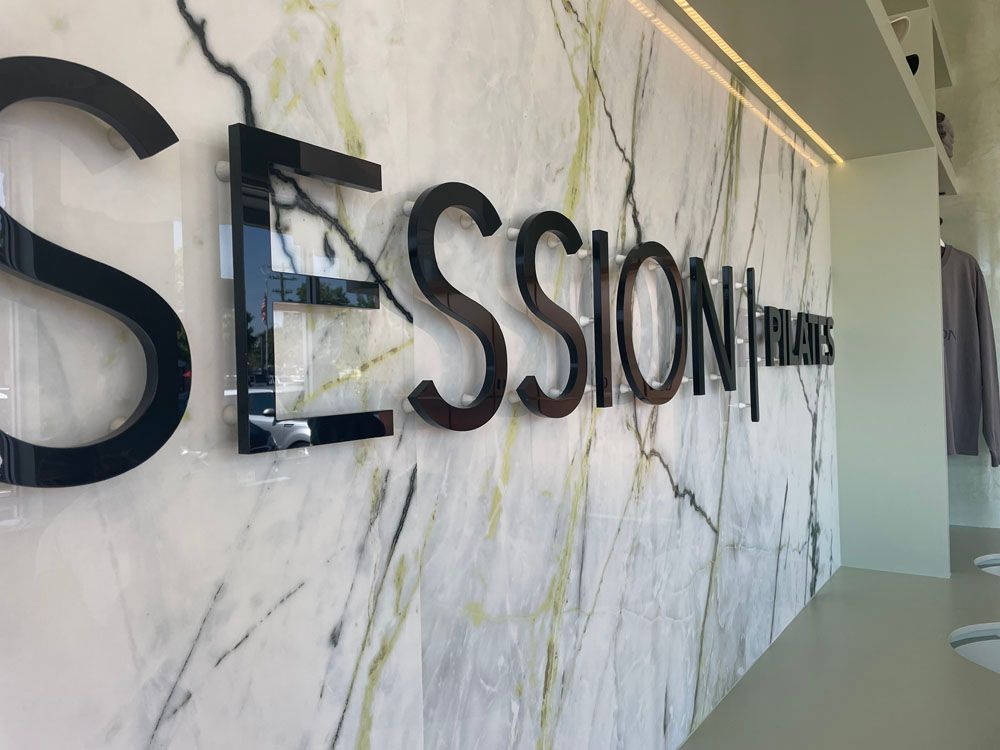 The word session is written on a marble wall