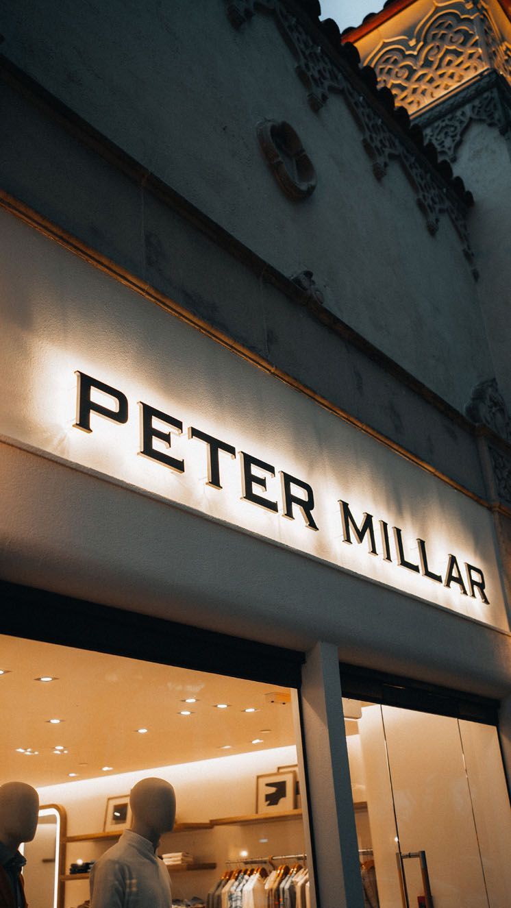 A storefront with a sign that says Peter Millar on it