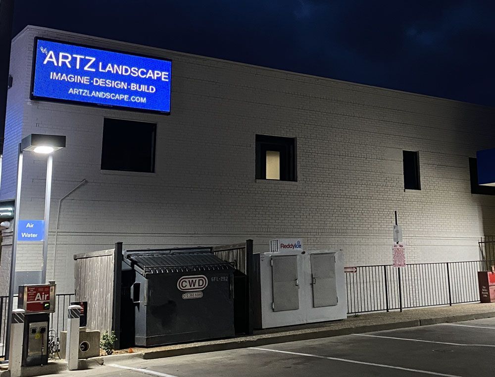 A building with a sign that says 'Artz Landscape' on it