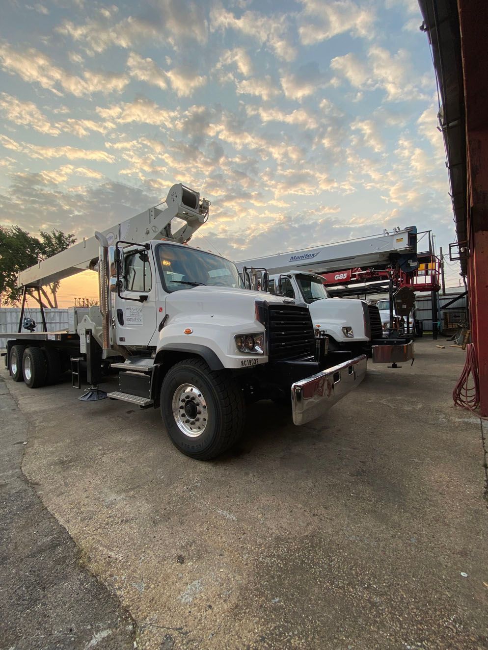A couple of trucks parked next to each other in a parking lot.