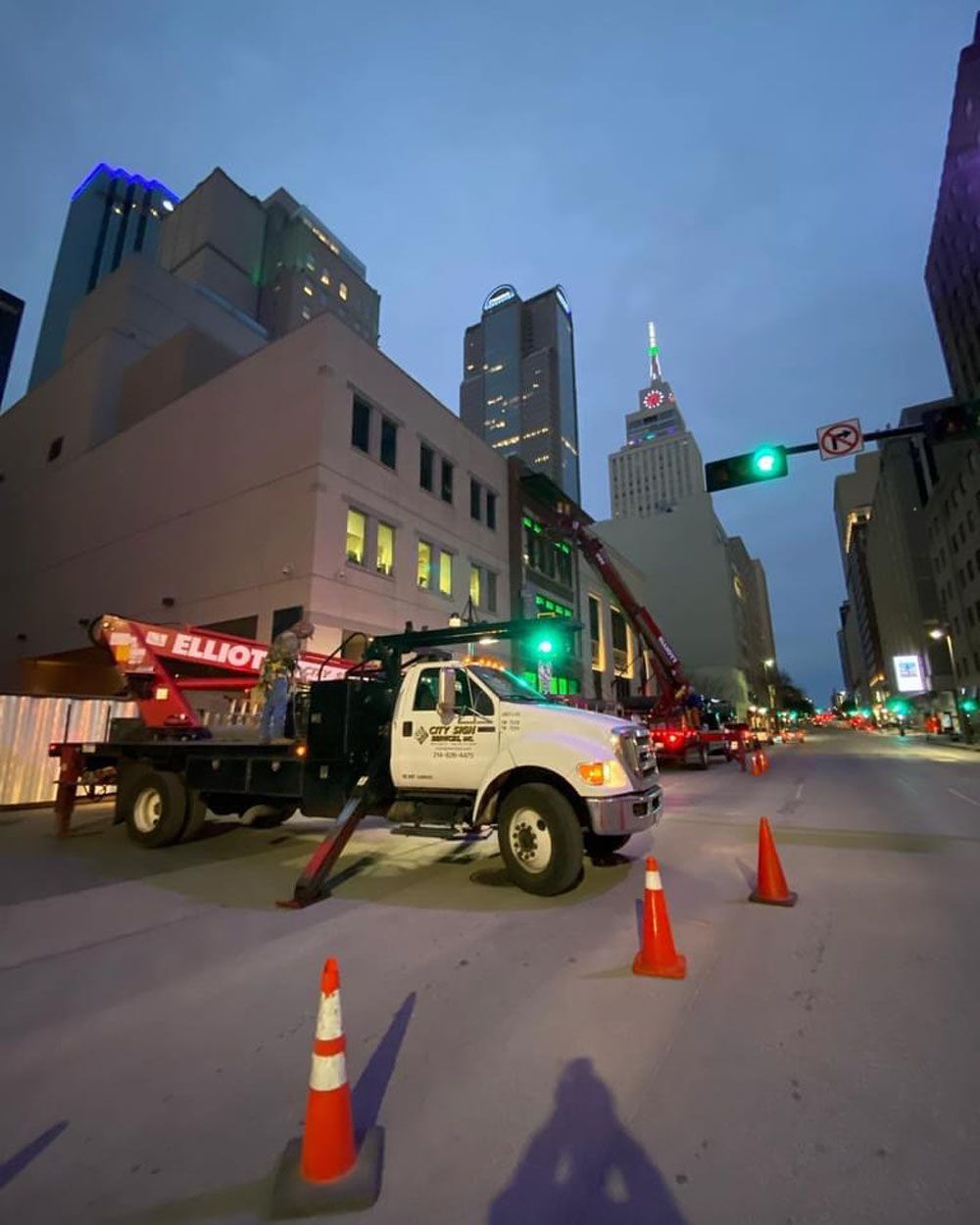 A white truck is parked in the middle of a city street