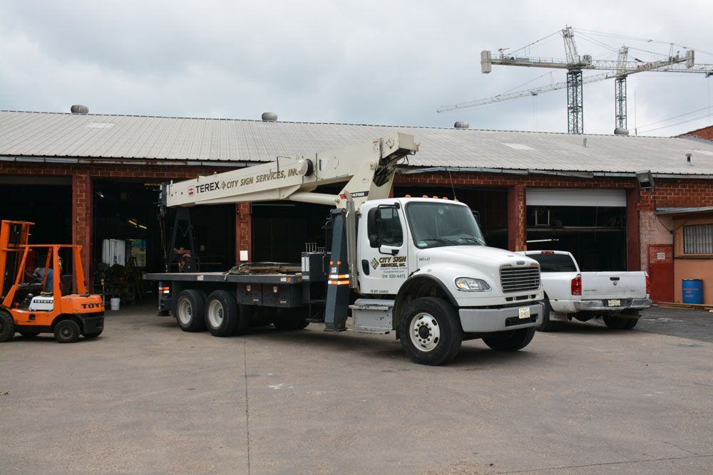 A Terex truck is parked in front of a building