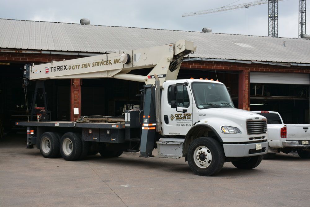 A Terex truck is parked in front of a building