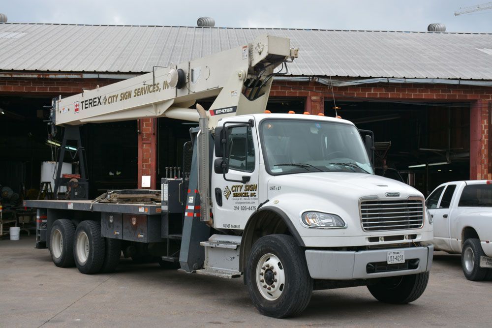 A Terex truck is parked in front of a building