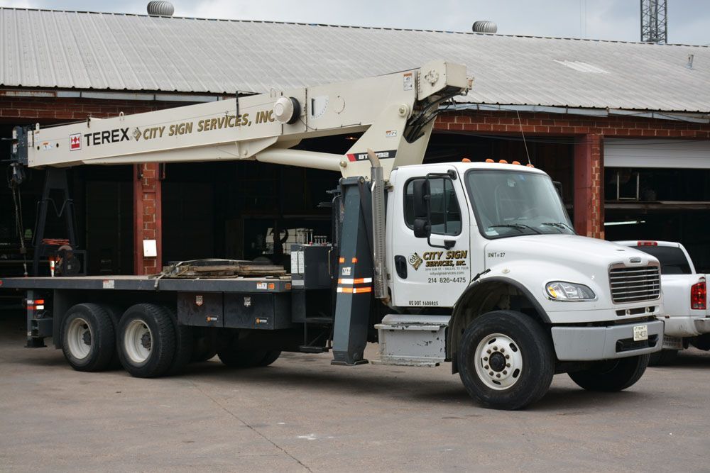 A Terex truck is parked in front of a building
