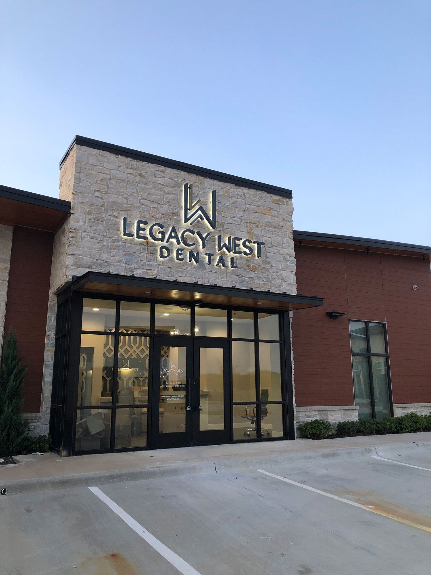 The front of a legacy west dental office with a parking lot in front of it