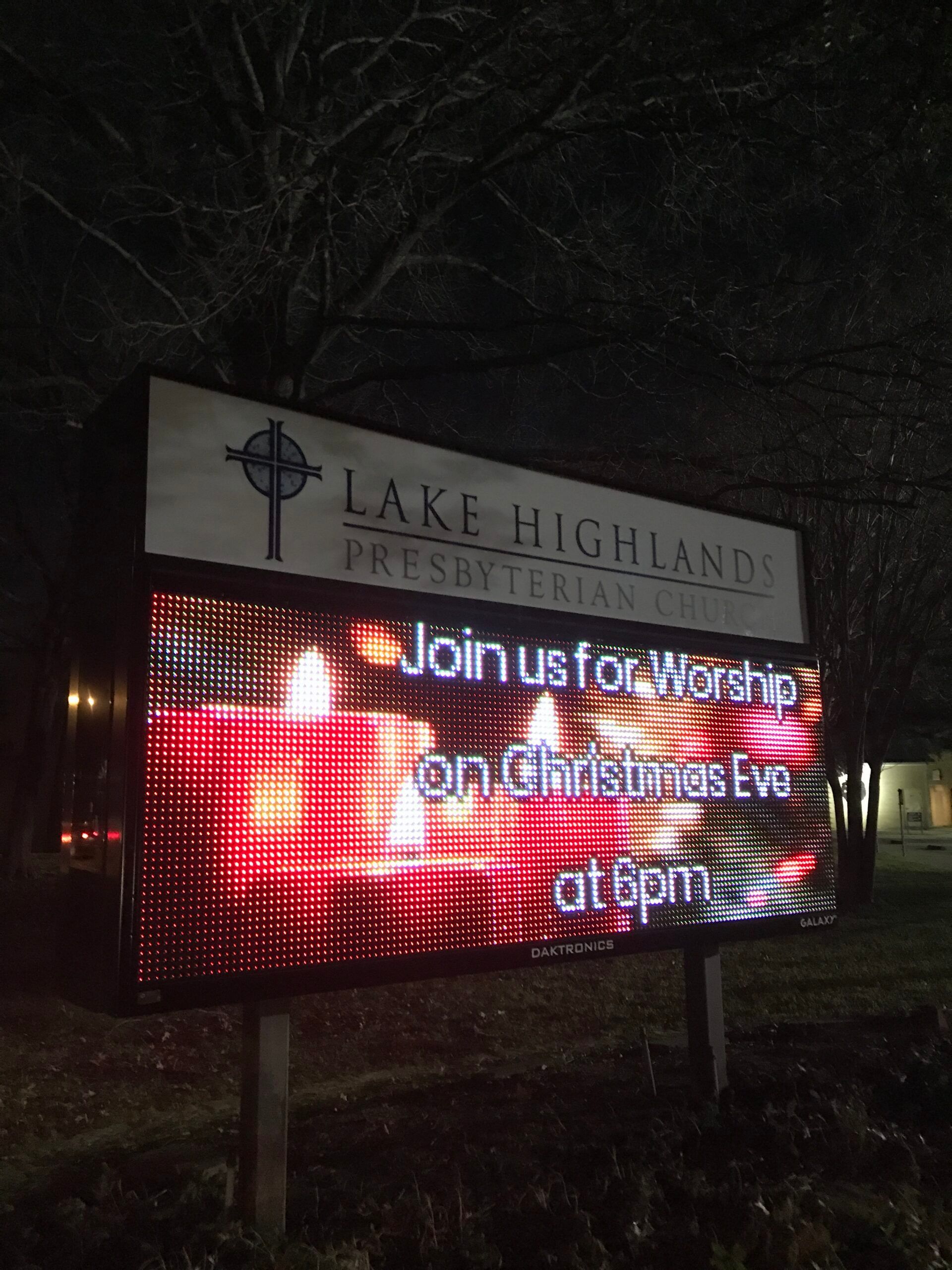 A sign for lake highland says join us for worship on christmas eve