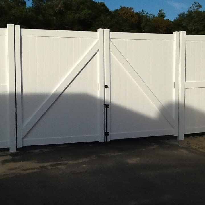 A white fence with a gate in the middle
