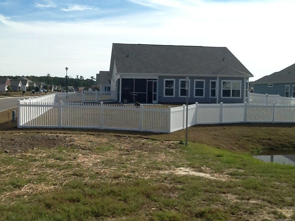 A house with a white picket fence around it