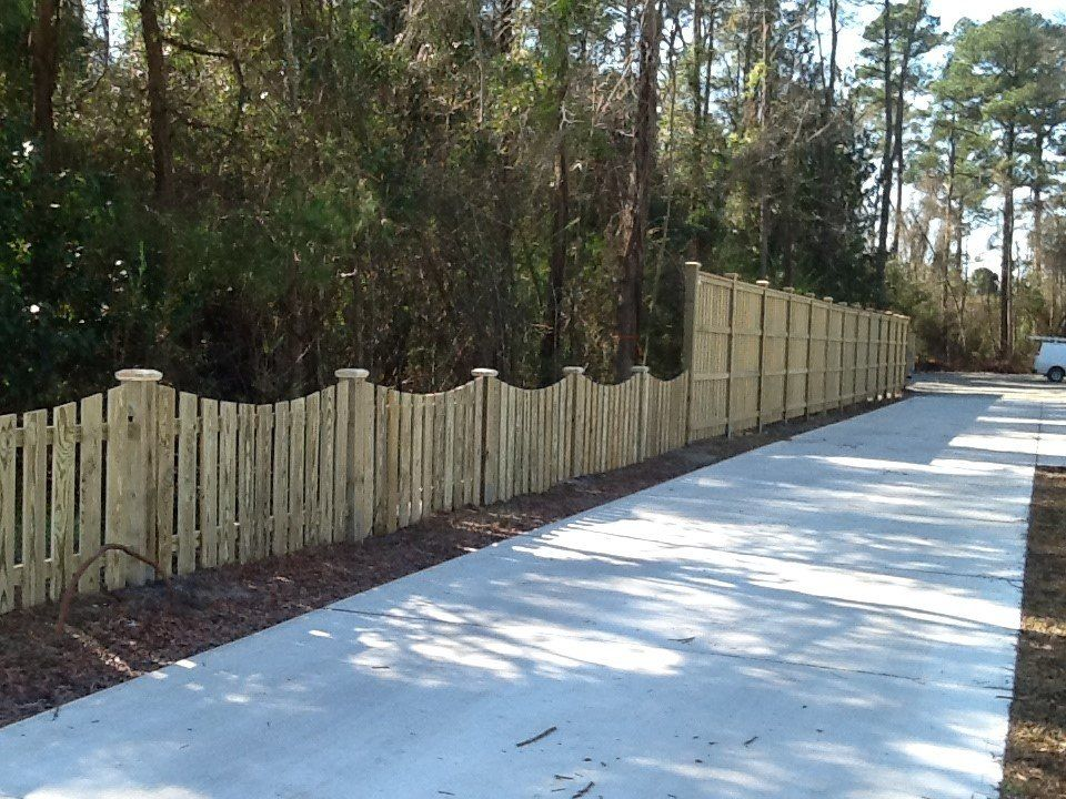 A wooden fence along the side of a road