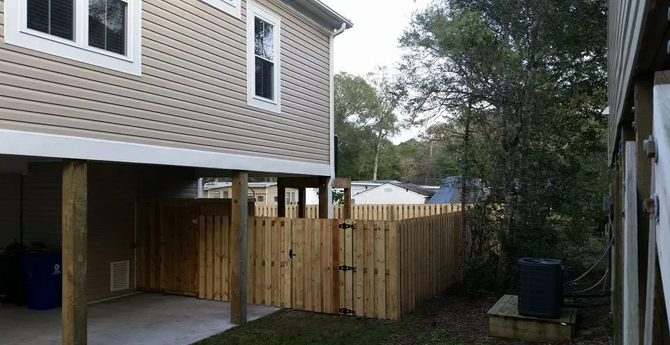 A house with a wooden fence in front of it